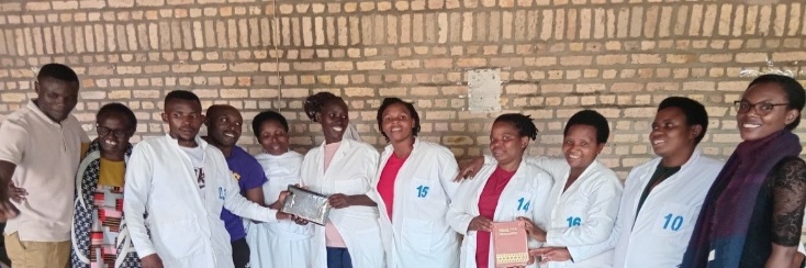 Rwandan schoolteachers holding Bibles and Child Evangelism Fellowship Wonder Books